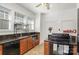 Traditional kitchen features tiled floor, granite countertops, black appliances, ceiling fan and plentiful natural light at 642 W Front St, Statesville, NC 28677