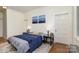 Main bedroom features blue bedding, wooden floors and mountain art at 642 W Front St, Statesville, NC 28677