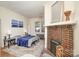 Main bedroom features blue bedding, brick fireplace and wooden floors at 642 W Front St, Statesville, NC 28677