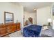 Main bedroom features blue bedding, wooden floors, a dresser and easy chair at 642 W Front St, Statesville, NC 28677