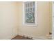 Bright, empty room with large window and hardwood floors at 642 W Front St, Statesville, NC 28677