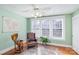 Bright sitting room with hardwood floors, large windows, a stylish globe, and a leather chair at 642 W Front St, Statesville, NC 28677