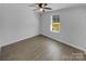 Clean and bright bedroom featuring hardwood floors, a fan, and a window at 733 Baker St, Kannapolis, NC 28081