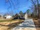 Quaint home featuring professional landscaping and a freshly poured driveway at 733 Baker St, Kannapolis, NC 28081