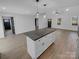 Kitchen island with granite countertops, wood floors, and modern fixtures at 733 Baker St, Kannapolis, NC 28081