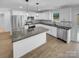 Modern kitchen featuring stainless steel appliances, granite countertops, and ample cabinet space at 733 Baker St, Kannapolis, NC 28081
