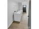 Hallway laundry room featuring washer, dryer, shelving and wood floors at 733 Baker St, Kannapolis, NC 28081