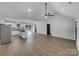 Spacious living room and kitchen area with vaulted ceiling, wood floors and ample natural light at 733 Baker St, Kannapolis, NC 28081