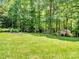 Expansive backyard with a shed, swing set, and landscaping at 821 Lynnwood Farms Dr, Fort Mill, SC 29715