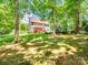 View of the home's backyard featuring a well-maintained lawn and a red wooden deck at 821 Lynnwood Farms Dr, Fort Mill, SC 29715