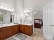 Bright bathroom featuring dual vanities, tile floors, and a view into the main bedroom at 821 Lynnwood Farms Dr, Fort Mill, SC 29715
