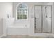 Bright bathroom featuring a large soaking tub, walk-in shower, and a window providing natural light at 821 Lynnwood Farms Dr, Fort Mill, SC 29715