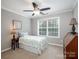 Neutral bedroom features a ceiling fan, large window, and comfortable furniture at 821 Lynnwood Farms Dr, Fort Mill, SC 29715