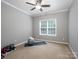 Minimalist bedroom featuring neutral colored carpet, walls, and a single window at 821 Lynnwood Farms Dr, Fort Mill, SC 29715