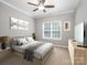 Serene bedroom with neutral tones, a large window, and a comfortable queen-sized bed with soft, decorative bedding at 821 Lynnwood Farms Dr, Fort Mill, SC 29715