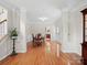 Charming dining room with hardwood floors, classic trim, and a view into the kitchen at 821 Lynnwood Farms Dr, Fort Mill, SC 29715