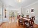 Open concept dining room with hardwood floors, adjacent to living room and kitchen at 821 Lynnwood Farms Dr, Fort Mill, SC 29715