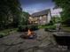 Outdoor stone fire pit with chairs creating a cozy backyard entertaining space at 821 Lynnwood Farms Dr, Fort Mill, SC 29715