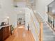Inviting foyer with hardwood floors, staircase, and views into the living room with fireplace at 821 Lynnwood Farms Dr, Fort Mill, SC 29715