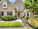 Inviting front entrance with manicured landscaping, a brick facade, and a decorative front door at 821 Lynnwood Farms Dr, Fort Mill, SC 29715