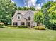 Well-manicured front lawn and garden beds leading up to this beautiful brick two-story home at 821 Lynnwood Farms Dr, Fort Mill, SC 29715