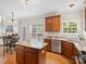 Bright kitchen offering an island with granite countertop, wooden cabinets, and stainless steel appliances at 821 Lynnwood Farms Dr, Fort Mill, SC 29715