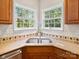 Double windows over sink provide lots of natural light in this corner of the kitchen at 821 Lynnwood Farms Dr, Fort Mill, SC 29715