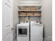 Convenient laundry room featuring a washer, dryer, storage shelves, and stylish baskets at 821 Lynnwood Farms Dr, Fort Mill, SC 29715