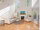 Spacious living room with high ceilings, hardwood floors, fireplace, and large windows at 821 Lynnwood Farms Dr, Fort Mill, SC 29715