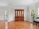 Bright living room featuring hardwood floors, large windows, and an elegant built-in china cabinet at 821 Lynnwood Farms Dr, Fort Mill, SC 29715