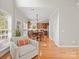 Comfortable sitting room with hardwood floors, and a glimpse of the eat-in kitchen at 821 Lynnwood Farms Dr, Fort Mill, SC 29715