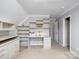 Office space with built-in shelves, desk, and storage cabinets under vaulted ceiling at 821 Lynnwood Farms Dr, Fort Mill, SC 29715