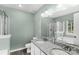 Bathroom with double-sink vanity, granite countertop, tile floors, and glass shower at 8421 Kings Creek Dr, Charlotte, NC 28273