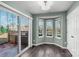 Sunny dining area featuring a bay window, sliding glass door to patio, and hardwood floors at 8421 Kings Creek Dr, Charlotte, NC 28273