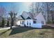 Well-maintained home with manicured lawn, inviting front porch, and charming architectural details at 8421 Kings Creek Dr, Charlotte, NC 28273