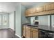 Kitchen with granite countertops, wood cabinets, and a seamless flow into the living space at 8421 Kings Creek Dr, Charlotte, NC 28273