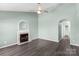 Bright living room featuring a cozy fireplace, ceiling fan, and hardwood floors at 8421 Kings Creek Dr, Charlotte, NC 28273