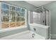 Bathtub and glass enclosed shower combination with window to exterior at 8421 Kings Creek Dr, Charlotte, NC 28273