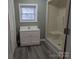 Bright bathroom featuring a walk-in shower, modern vanity, and a window that brings in natural light at 927 Locke St, Salisbury, NC 28144