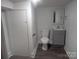 Bathroom with modern toilet, sink and mirror plus a door leading to more space at 927 Locke St, Salisbury, NC 28144