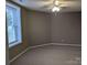 Cozy bedroom with soft carpet flooring, a ceiling fan, and a bright window overlooking the outdoors at 927 Locke St, Salisbury, NC 28144