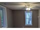 View of a living room featuring two windows, fresh paint, a ceiling fan, and blinds at 927 Locke St, Salisbury, NC 28144