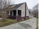 Side view of the home, highlighting the brick foundation, siding, and driveway leading to the garage at 927 Locke St, Salisbury, NC 28144