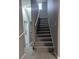 Gray carpeted staircase with neutral gray walls and white trim leading to the upper level at 927 Locke St, Salisbury, NC 28144