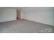 Large room featuring plush carpeting, white walls, and natural light from doorway at 0000 Trull Hinson Rd # 1, Wingate, NC 28174