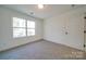A bright bedroom with a large window, plush carpeting and white painted walls at 0000 Trull Hinson Rd # 1, Wingate, NC 28174