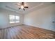 Spacious primary bedroom featuring tray ceilings, natural light, and wood flooring at 0000 Trull Hinson Rd # 1, Wingate, NC 28174