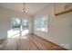 Bright dining room with wood floors, modern chandelier, and natural light at 0000 Trull Hinson Rd # 1, Wingate, NC 28174