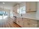 Farmhouse sink, white subway tile, stainless steel appliances, and white cabinets in this new kitchen at 0000 Trull Hinson Rd # 1, Wingate, NC 28174
