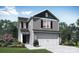 Charming two-story home with gray siding, a two-car garage, and well-manicured landscaping at 102 Lightning Dr, Shelby, NC 28152